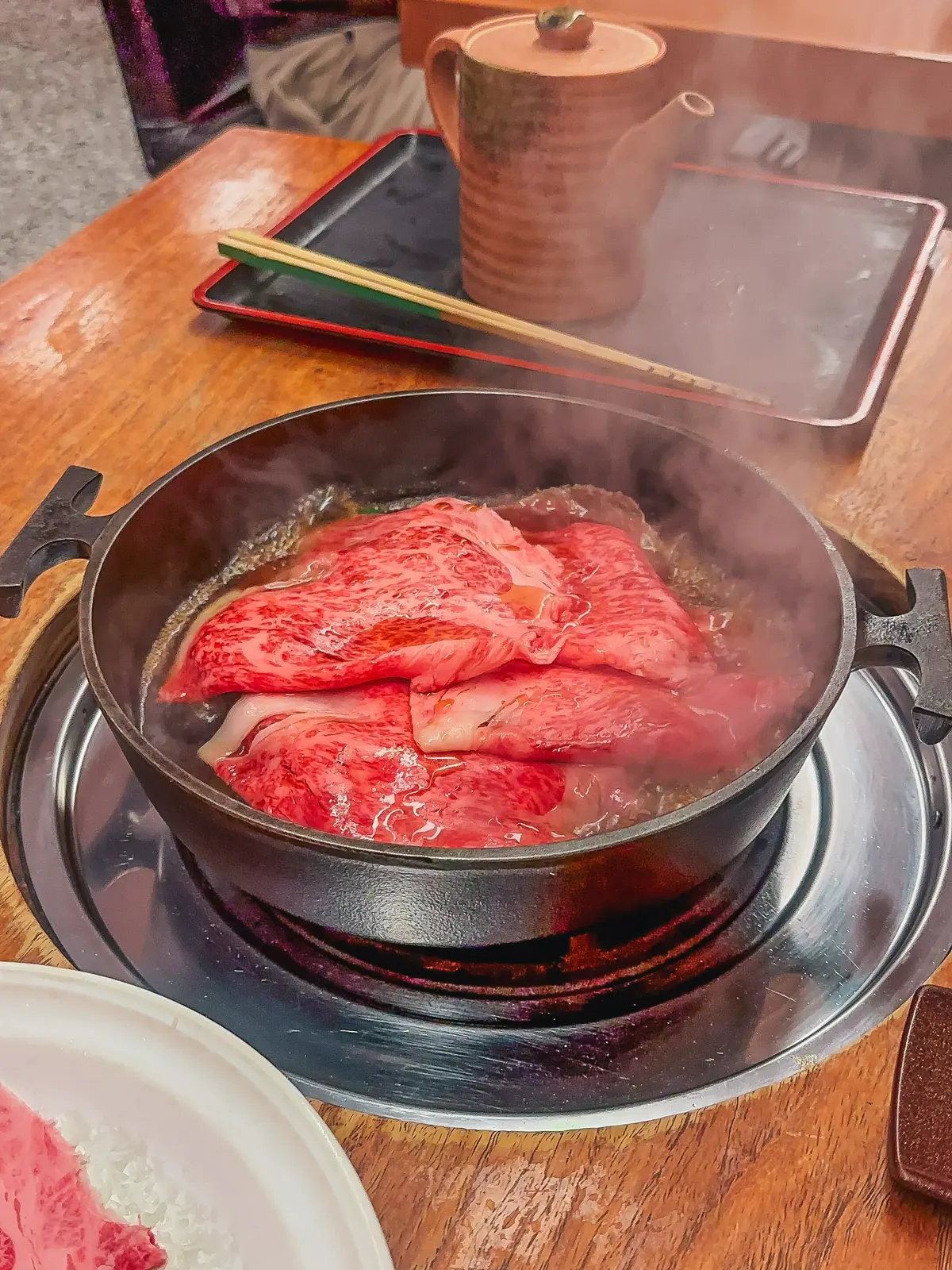 Cooking meat at Sukiyaki Matsukiya in Shibuya