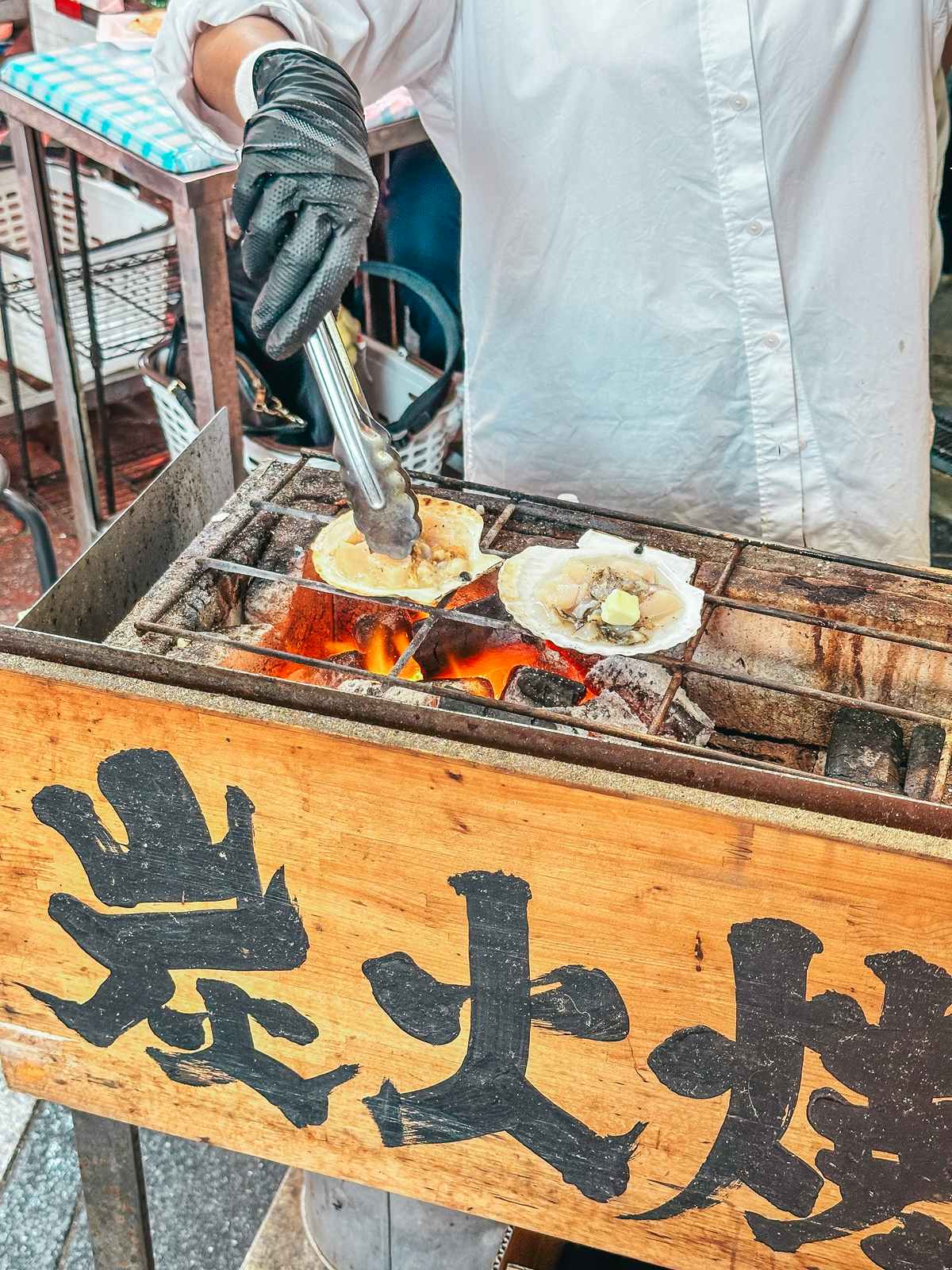 Scallop preparation at the Kuromon Ichiba Market in Osaka